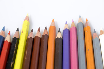 Colored pencils in a white background composition