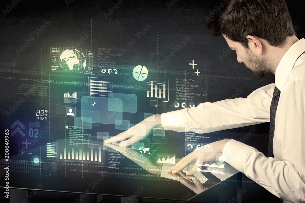 Poster businessman touching interactive modern desk with technology icons on table