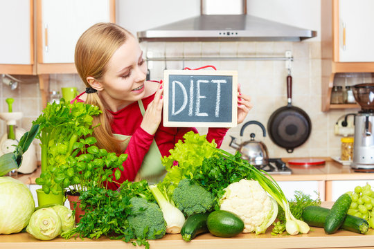 Woman in kitchen having green diet vegetables