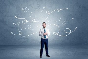 Elegant businessman choosing between directions with winding drawn arrows around 
