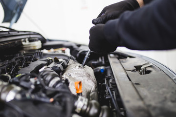 Auto mechanic repairing car. Selective focus. 