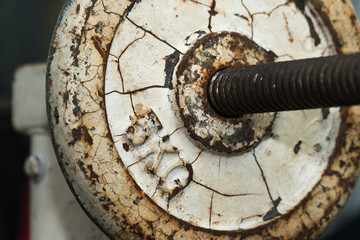 Rusted barbell in a gym. It look like no one to maintenance for long time ago..Vintage barbell. Image for be background. Copy space. Sport and Health Concept.