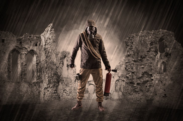 Hazard, menace man in a ruined crumbly building with arms on his hand
