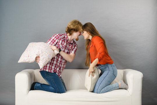 Angry couple having pillow fight