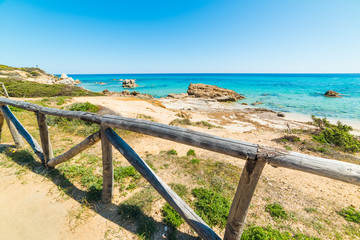 Fototapeta premium Wooden handrail by the sea in Costa Rei