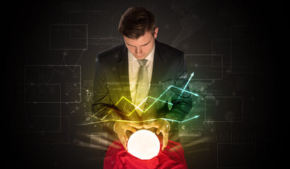 Young businessman making predictions of the future of the stock market with a magic ball
