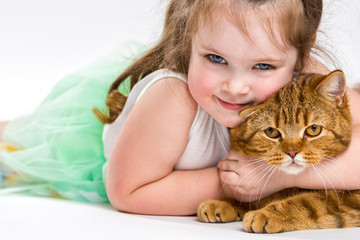 Portrait of a child with a cat. Beautiful girl closeup