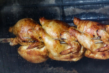Chickens Roasting on Spit