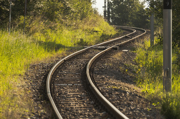 Curvy track/Railroad track making two consecutive opposing curves through a forest.