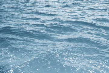 Water surface with ripples and sunlight reflections