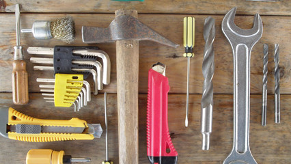 Locksmith tools on wooden background.