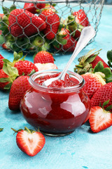 strawberry jam with fresh strawberries. marmalade on spoon and jar