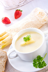 asparagus cream soup with capers and fresh baguette