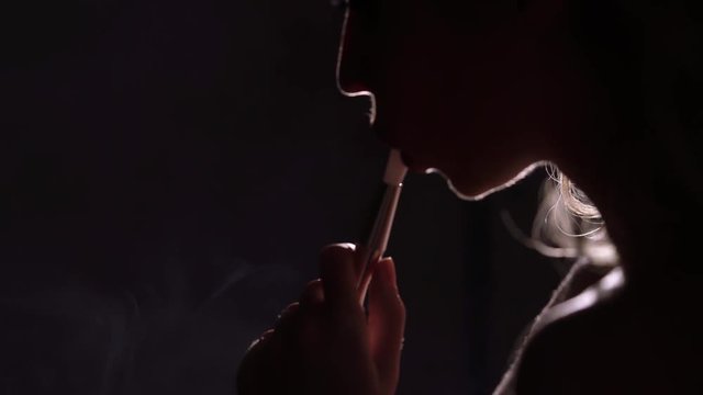 Young woman smoking hookah silhouette