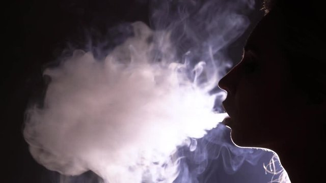 Young woman smoking hookah silhouette