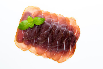 Italian prosciutto crudo or jamon. Raw ham. Isolated on white background