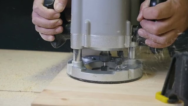 Carpenter working of manual milling machine in the carpentry workshop. slow motion