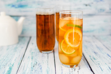refreshing tea with ice cubes, lemon and lime slices