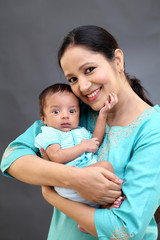 Cheerful mother holding newborn baby - 200668924