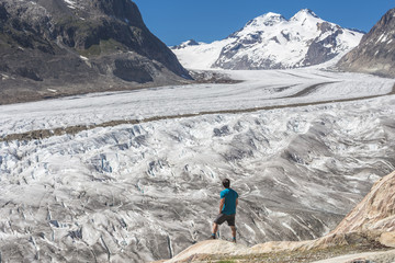 Naklejka premium Lone male climber looking out, Aletsch Glacier, Canton Wallis, Switzerland