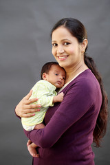 Cheerful mother holding newborn baby - 200668990