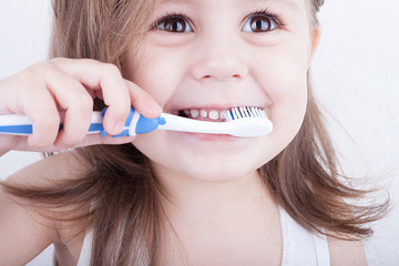 Cute little girl brushing her teeth