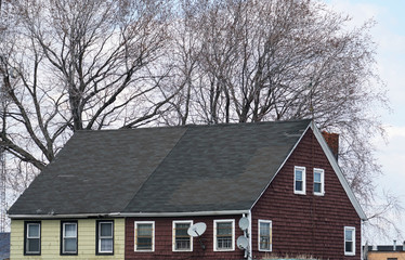 old house exterior with tree branch in winter