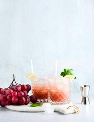 pink non-alcoholic  moсktail made from grapes with lemon and mint. summer refreshing drink