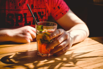 Man drinks cocktail in bar 