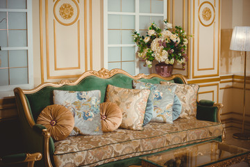 Luxurious living room in green beige tones 