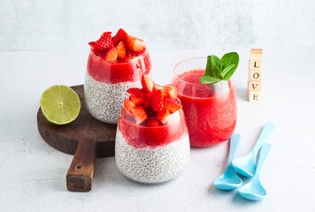 morning breakfast desserts in glasses. pudding from seeds of chia and coconut milk and puree from ripe strawberry. a light summer snack for children or athletes. Dietary healthy food.