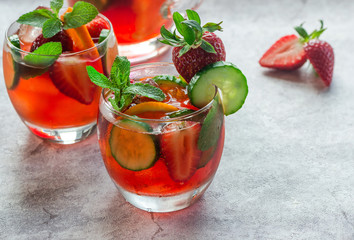 Traditional Pimms cocktail with lemonade, strawberries, cucumber