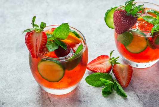 Traditional Pimms cocktail with lemonade, strawberries, cucumber