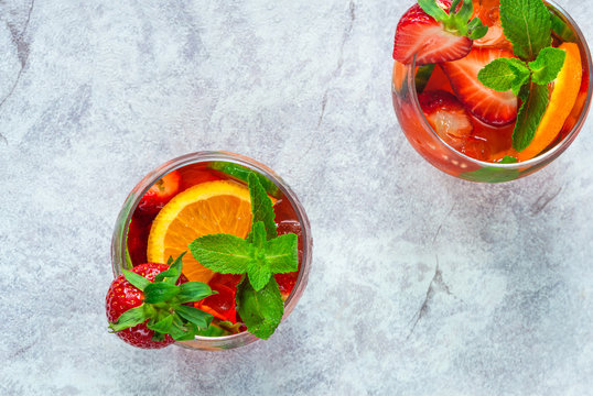 Traditional Pimms cocktail with lemonade, strawberries, cucumber