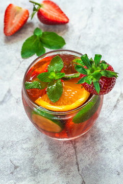 Traditional Pimms cocktail with lemonade, strawberries, cucumber