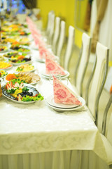 banquet hall of the restaurant, beautifully decorated tables with food	