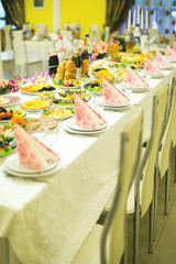 banquet hall of the restaurant, beautifully decorated tables with food	
