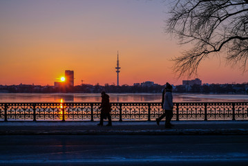 sunset on the coast in Hamburg, Germany, TV tower, peopleon the bridge