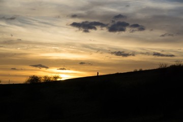 People on the horizon of meadow during sunset. Slovakia