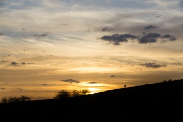 People on the horizon of meadow during sunset. Slovakia