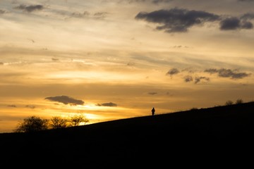 People on the horizon of meadow during sunset. Slovakia