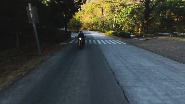 woman riding bike on road near Pico de loro in Philippines