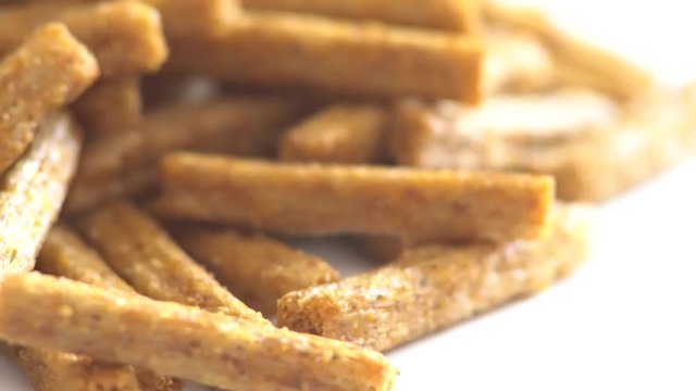 Portion of rotating Bread Chips as seamless loopable 4K UHD footage