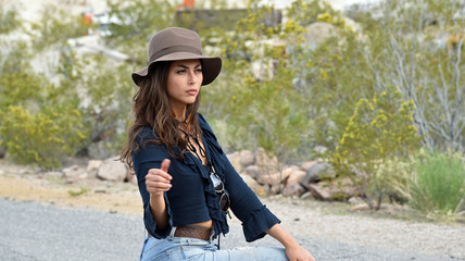 Woman with hat hitchhiking