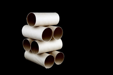 Stacked Toilet Paper Cardboard Tubes on Black