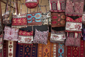 Fototapeta premium colorful fabrics and other folk products at a roadside stall with traditional Armenian colors and patterns
