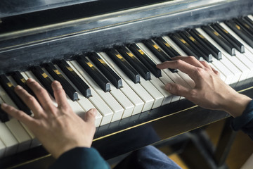 Close-up of a music performer's hand playing the piano.
