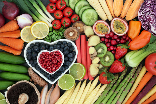 Super food for healthy eating concept with fresh fruit and vegetables forming an abstract background. Health food high in anthocyanins, antioxidants, vitamins, minerals and dietary fibre.