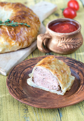 Portion of beef Wellington with tomato sauce