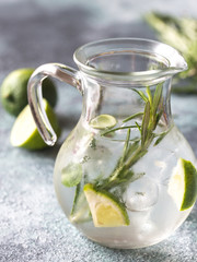 Glass jar of lime water with herbs